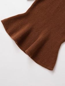 Close-up of deep brown rib-knit fabric texture on the hem and cuffs of women's sweater