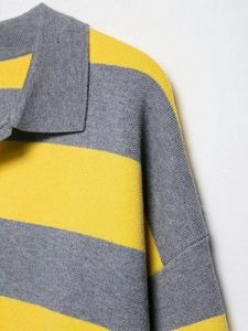Detail of grey and yellow striped knitted Polo shirt showing the collar and shoulder seams