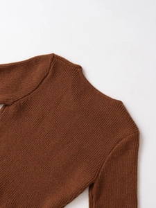 Detail of the caramel ribbed knit texture and back neckline stitching on the sweater
