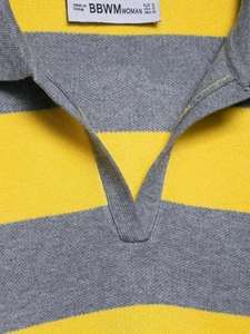 Close-up of the V-neck polo collar on this grey and yellow striped knit sweater