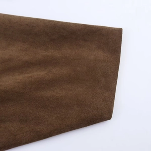 Close-up of dark brown faux suede fabric with soft texture on pilot jacket