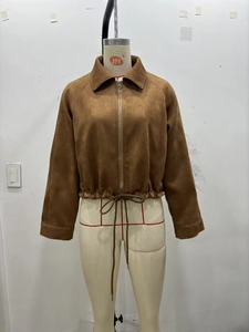Detail of a brown faux suede cropped jacket featuring lapel collar and adjustable drawstring hem