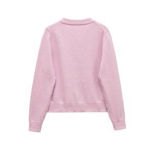 Detail view of pink wool blend knit cardigan featuring ribbed hem and back texture