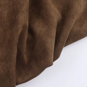 Detail shot of the dark brown faux suede fabric texture and soft material folds