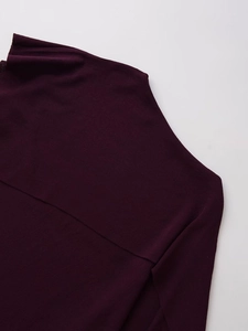 Detailed close-up showing the diagonal neckline and fine knit texture of the purple top