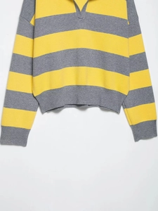 Detail of yellow and grey striped knit sweater featuring a ribbed V-neck polo collar
