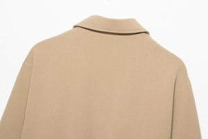 Détail de la veste kaki en sergé montrant la texture du tissu et le col à revers élégant