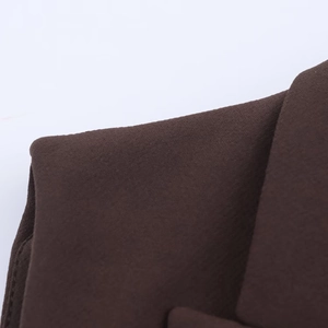 Gros plan sur un tissu en maille marron foncé avec des coutures précises et lisses