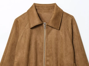 Detailed view of brown faux suede jacket featuring metal zipper and classic collar