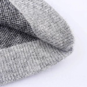 Close-up of leopard pattern knit sweater jacket with soft texture and ribbed hem detail