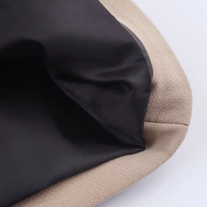 Detailed macro view of khaki canvas exterior and black inner lining of this blazer