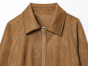 Detail of lapel collar and silver metal zipper on brown faux suede crop jacket