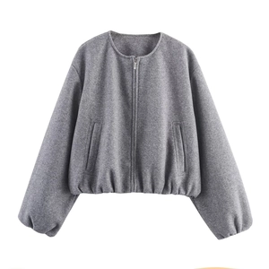 Detail of grey cropped bomber jacket featuring a metal zipper and soft wool-like texture
