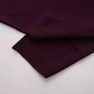 Elegant deep purple knit poncho sweater with refined ribbed cuffs and fine texture