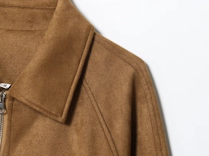 Detail view of brown suede jacket showing lapel collar, metal zipper, and size S label
