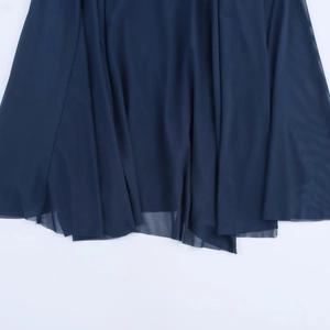 Close-up of sheer dark blue mesh fabric with fine net texture on a maxi dress hem