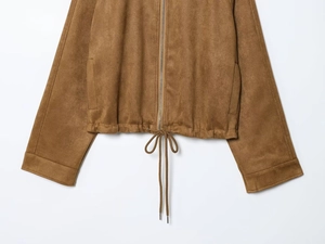 Detail of brown faux suede jacket hem with metal zipper and adjustable drawstring