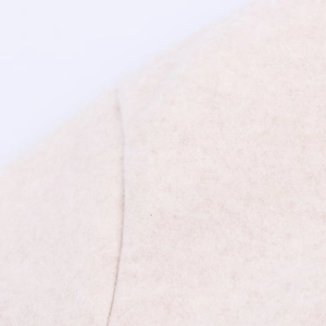 Detailed macro view of soft oatmeal wool fabric texture on a women bomber jacket
