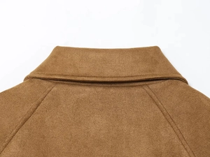 Close-up of a brown velvet jacket collar showing fine stitching and wool texture