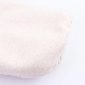 Macro shot of soft off-white plush fabric texture for bomber jacket material detail