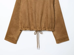 Detail of the brown suede jacket featuring a drawstring hem with metal tips