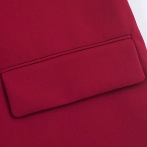 Close-up of the flap pocket and premium fabric texture on this burgundy oversized blazer