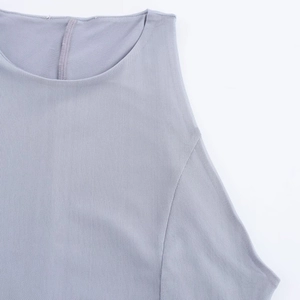 Close-up of the grey sleeveless dress showing breathable mesh fabric and fine neck seam