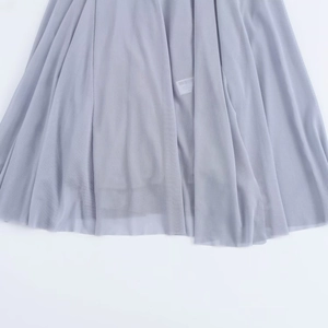 Detail of multi-layered light purple tulle fabric with smooth hem and inner tag