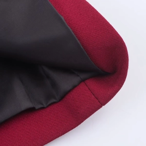 Detail of burgundy blazer showing premium woven fabric and black silky lining with fine stitching