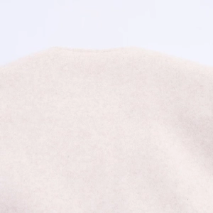 Detailed close-up showing soft wool blend texture and shoulder seam of the bomber jacket