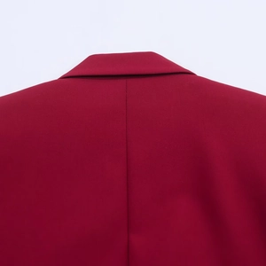 Close-up of the notched lapel and smooth back shoulder of a burgundy oversized blazer