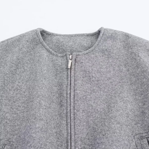 Close-up of grey wool-blend bomber jacket fabric with silver metal zipper detail