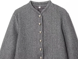 Close-up of gray tweed jacket neckline with silver metal buttons and size label