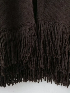 Detail of chocolate brown knit cardigan featuring layered long fringe and fine texture