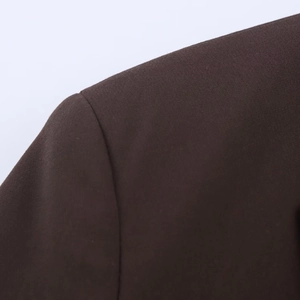Close-up of the shoulder seam and texture on a coffee brown oversized blazer jacket