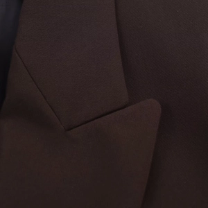 Detailed view of the notched lapel and woven texture on this oversized dark brown blazer
