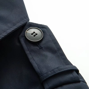Detailed macro view of dark navy twill fabric shoulder strap with a black button closure