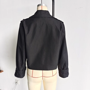 Back view detail of black cropped jacket featuring shoulder epaulettes and adjustable cuffs