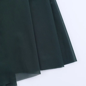 Close-up of high-quality dark green mesh fabric with a fine breathable texture
