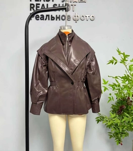 Detail of dark brown faux leather jacket featuring high collar and cinched waist design