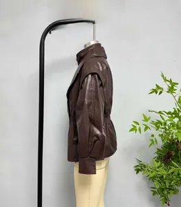 Detail of dark brown faux leather jacket featuring elastic waist and stand collar design