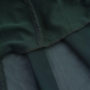 Detail of dark green sleeveless dress showing mesh fabric texture and seamless stitching