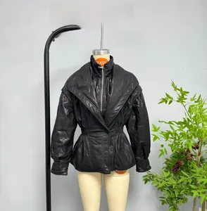 Detail of black faux leather jacket with double collar design and cinched waist for women