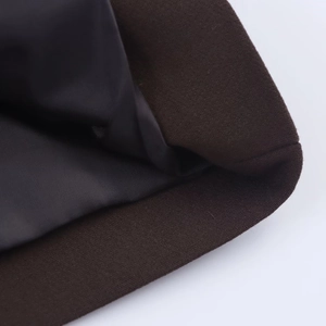 Macro detail of dark brown suit jacket fabric texture and smooth black lining