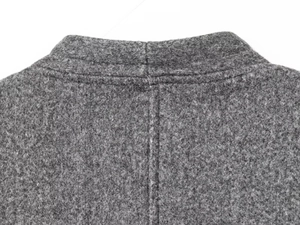 Detailed view of the back collar seam on a gray wool blend coat with sturdy stitching
