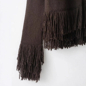 Dark brown round neck knit cardigan with long decorative fringe detailing and textures