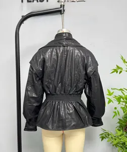 Detail view of the elastic cinched waist and hem on this vintage black faux leather jacket