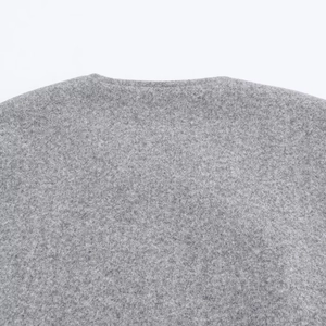 Close-up of soft grey wool texture on neckline and shoulder of bomber jacket