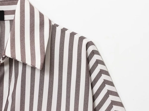 Detail of shoulder seam and fabric texture on brown striped linen blend shirt