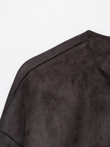 Detail view showing stitching and faux suede texture on a vintage brown jacket shoulder
